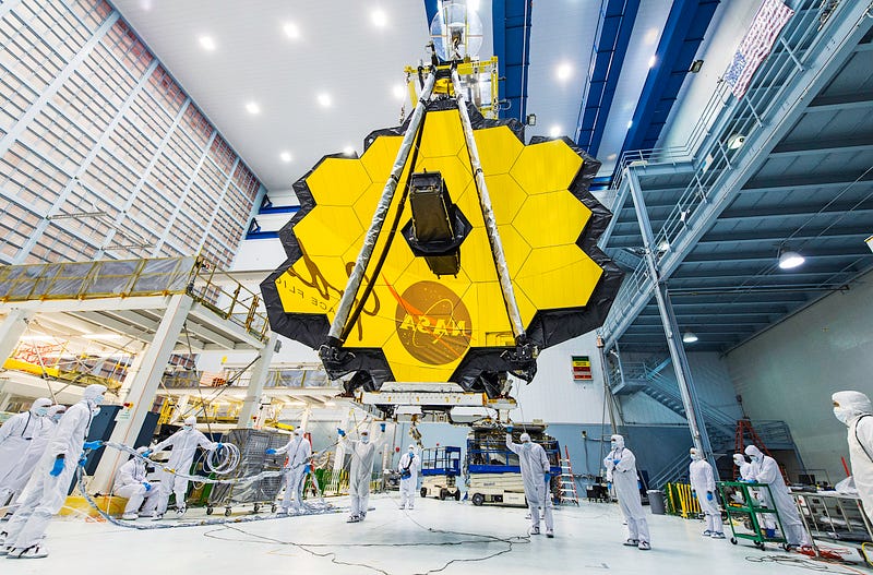 NASA technicians lifting the James Webb Space Telescope